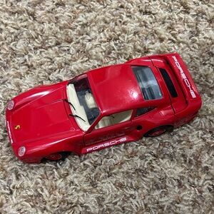 red die-cast model of a Porsche 959.